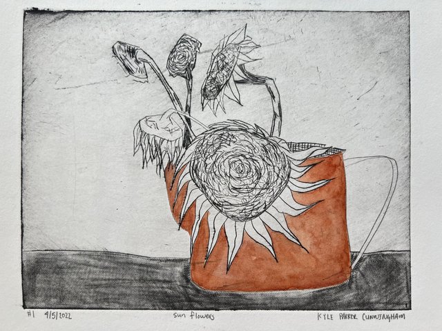 Intaglio drypoint print of sunflowers in a mug, with a large spiraling flower head in the foreground and several smaller blooms rising above, hand-colored with warm burnt orange on the mug and petals against a scratched gray background.